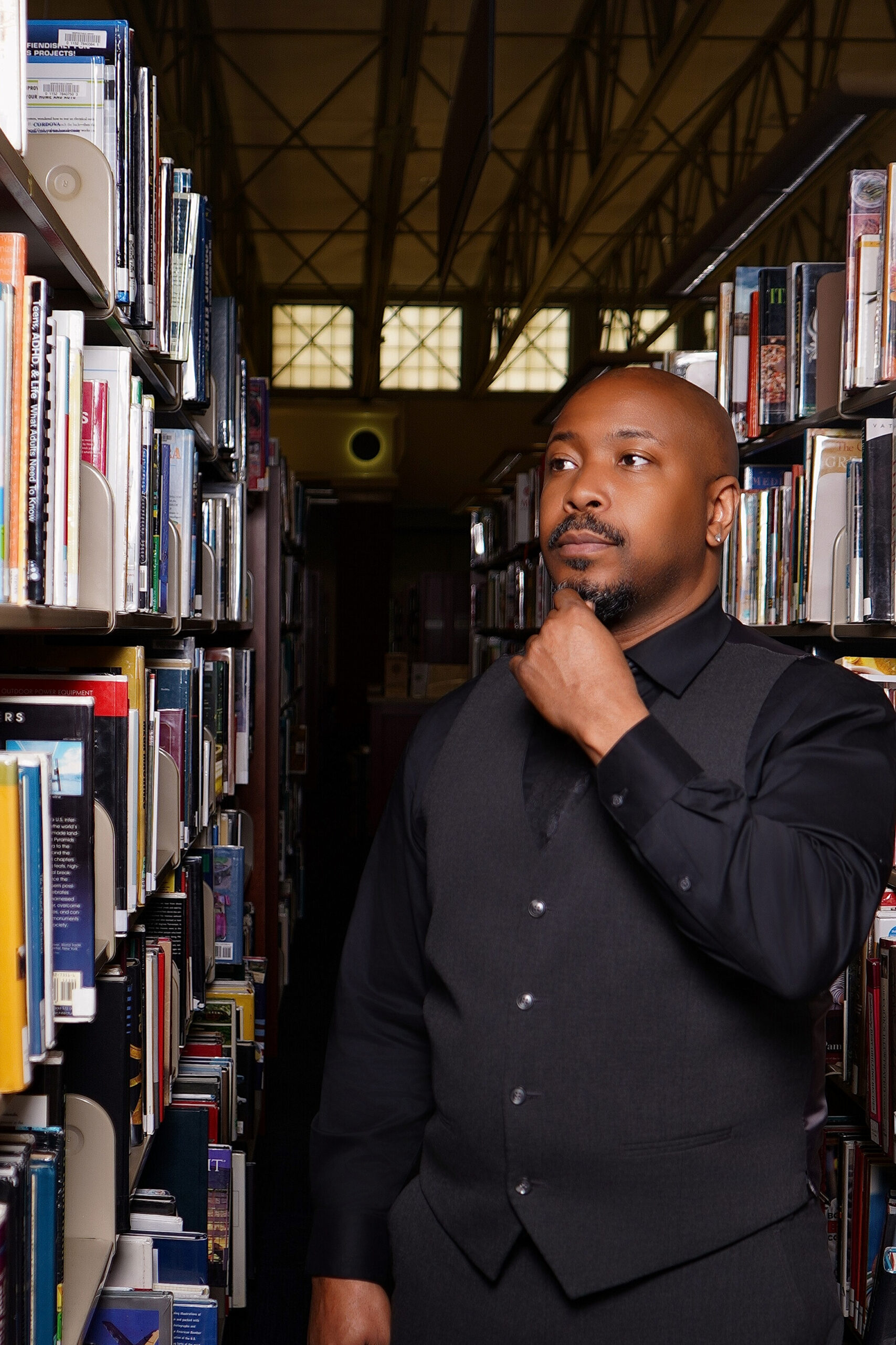 Jerome McNeary reflecting in a library